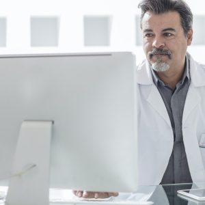 Male doctor working at computer